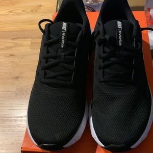 Nike women’s size 10 revolution 5 sneakers. Black with white shoosh. Never worn